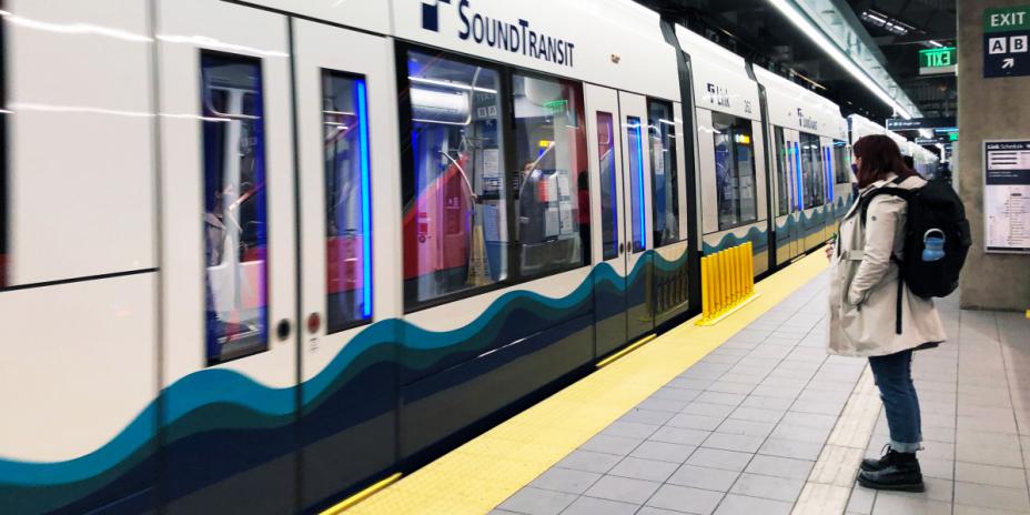 Person waiting for train at train station stop